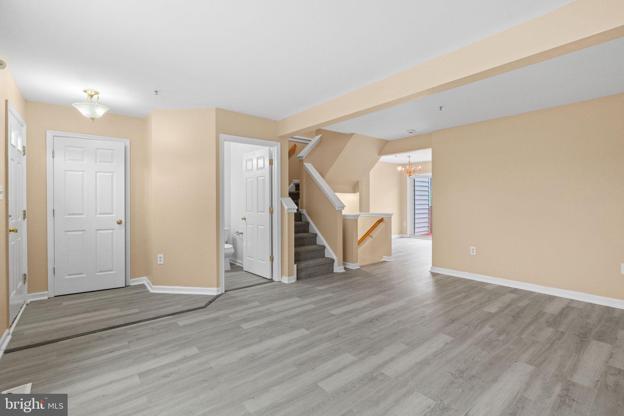 1703 Orchard View Road Reading, PA 19606 - Photo 8 of 53 a view of an empty room with wooden floor and stairs