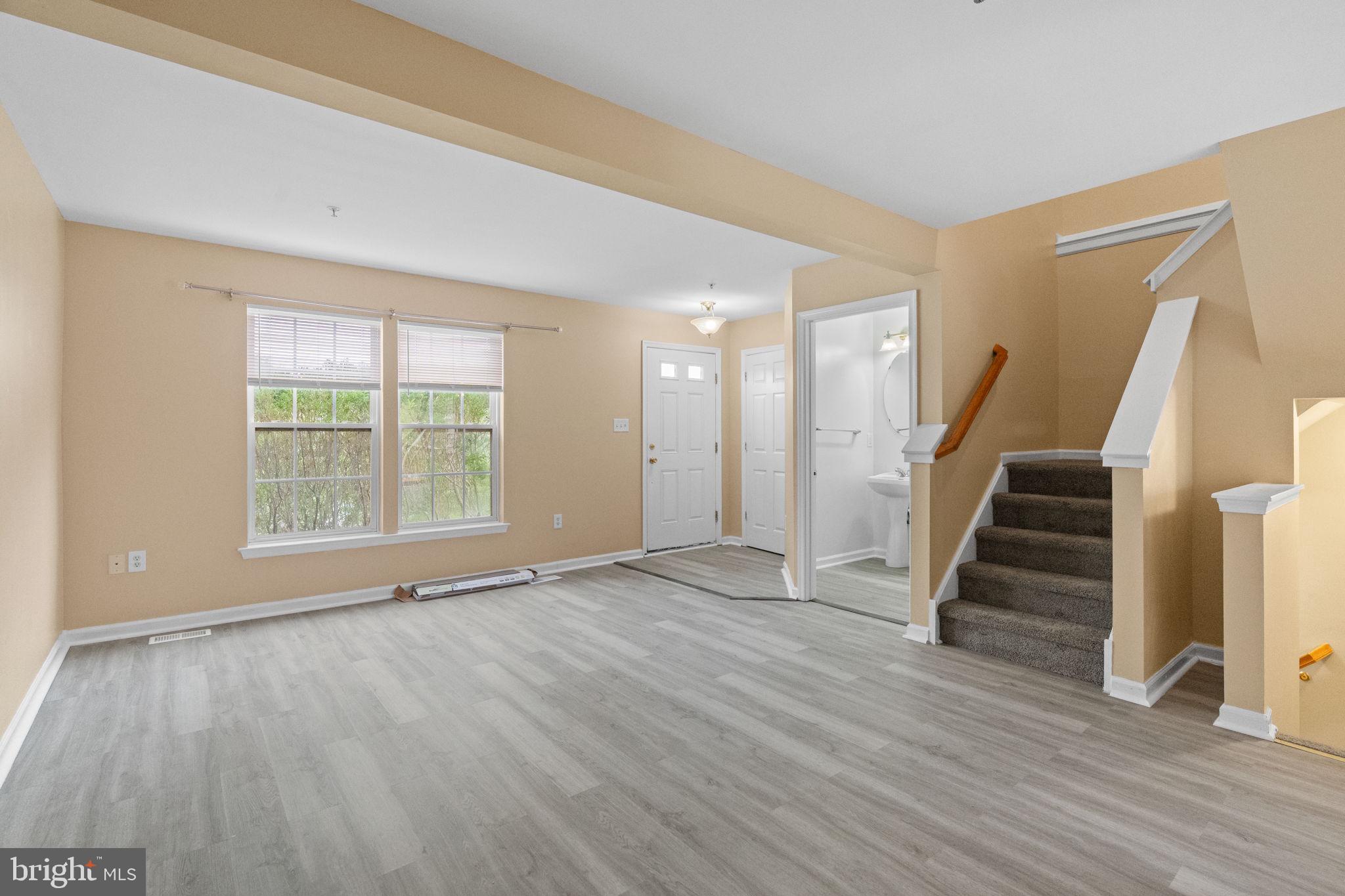 1703 Orchard View Road Reading, PA 19606 - Photo 9 of 53 a view of an empty room with wooden floor and stairs