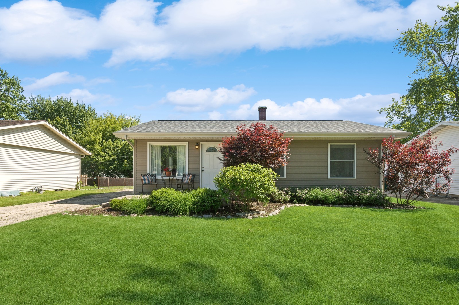 a front view of a house with a garden