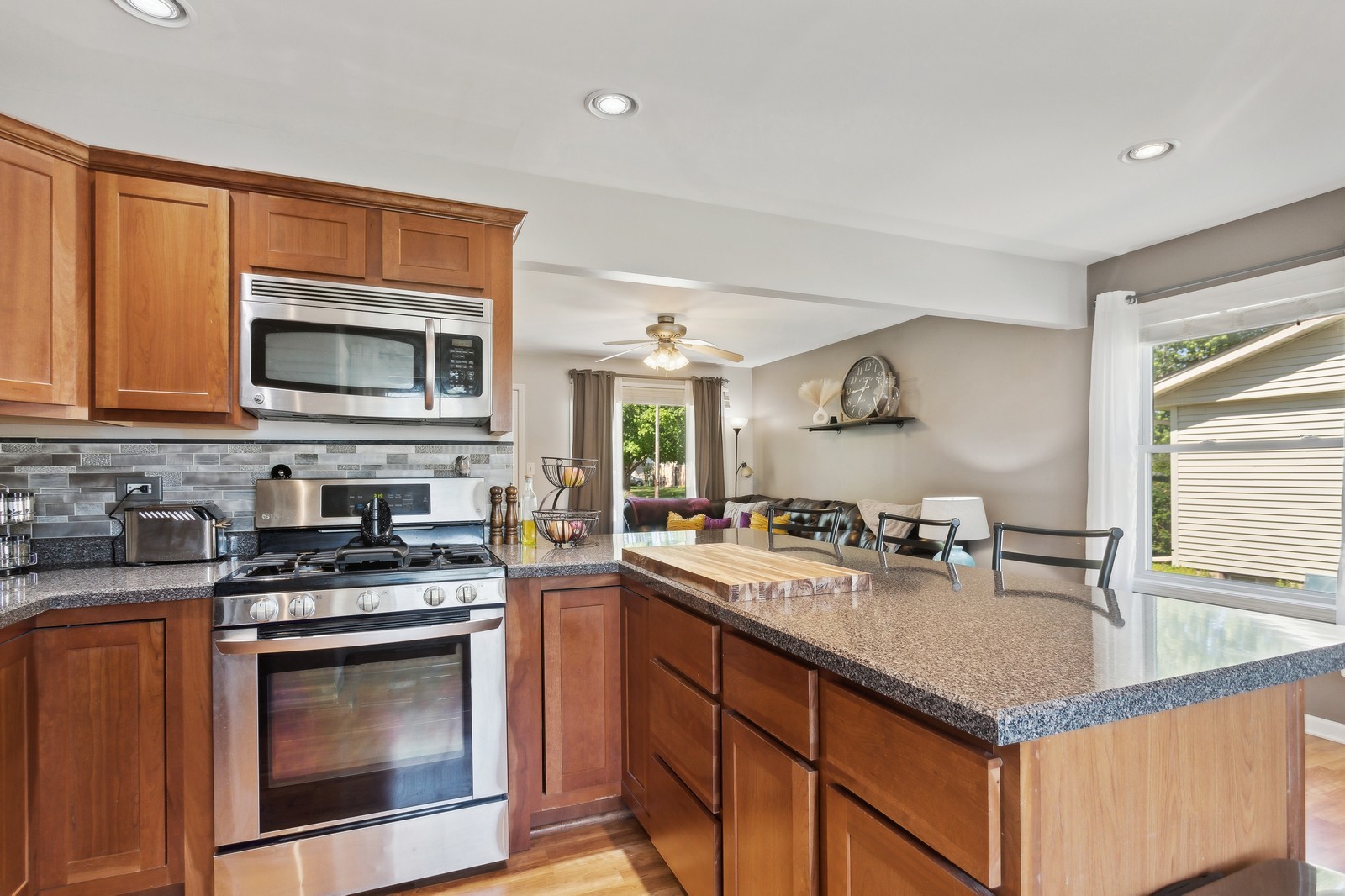 1201 Basin Drive Lockport, IL 60441 - Photo 6 of 16 a kitchen with granite countertop a stove sink and microwave