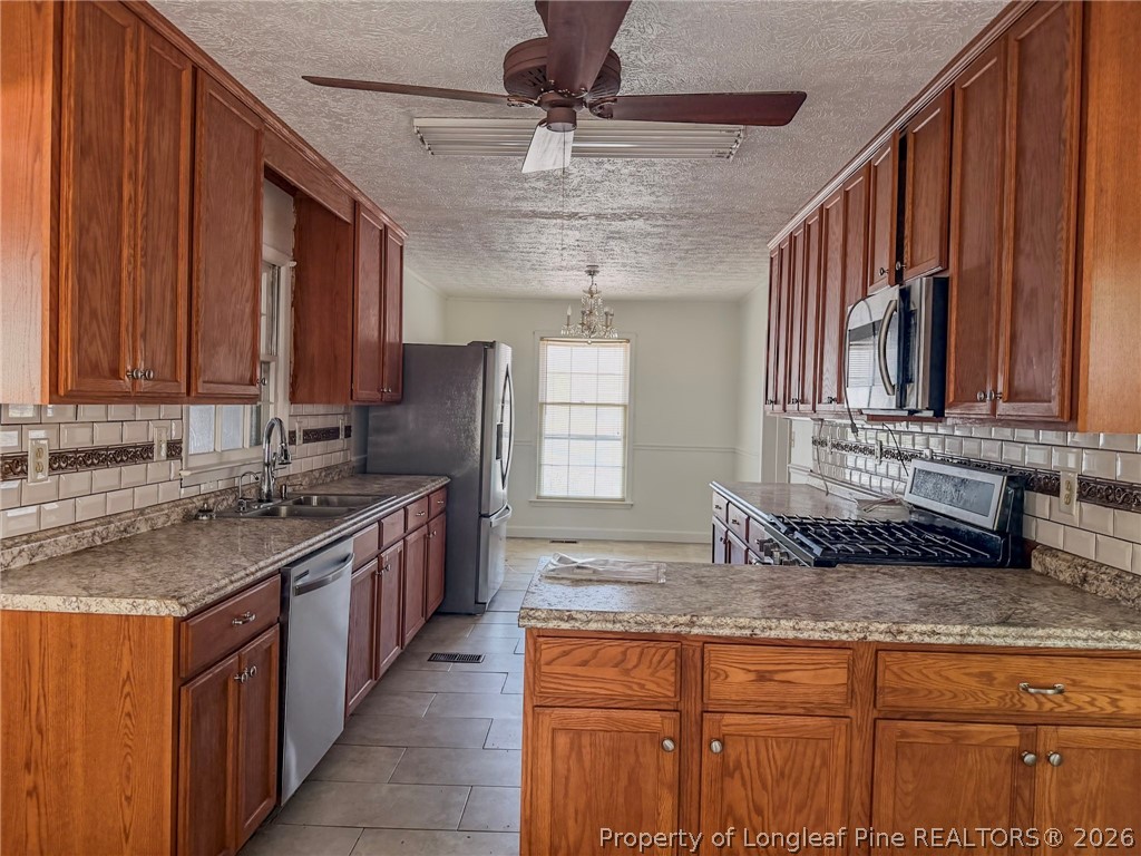 575 Veterans Road St. Pauls, NC 28384 - Photo 4 of 27 a kitchen with stainless steel appliances granite countertop a sink stove and cabinets