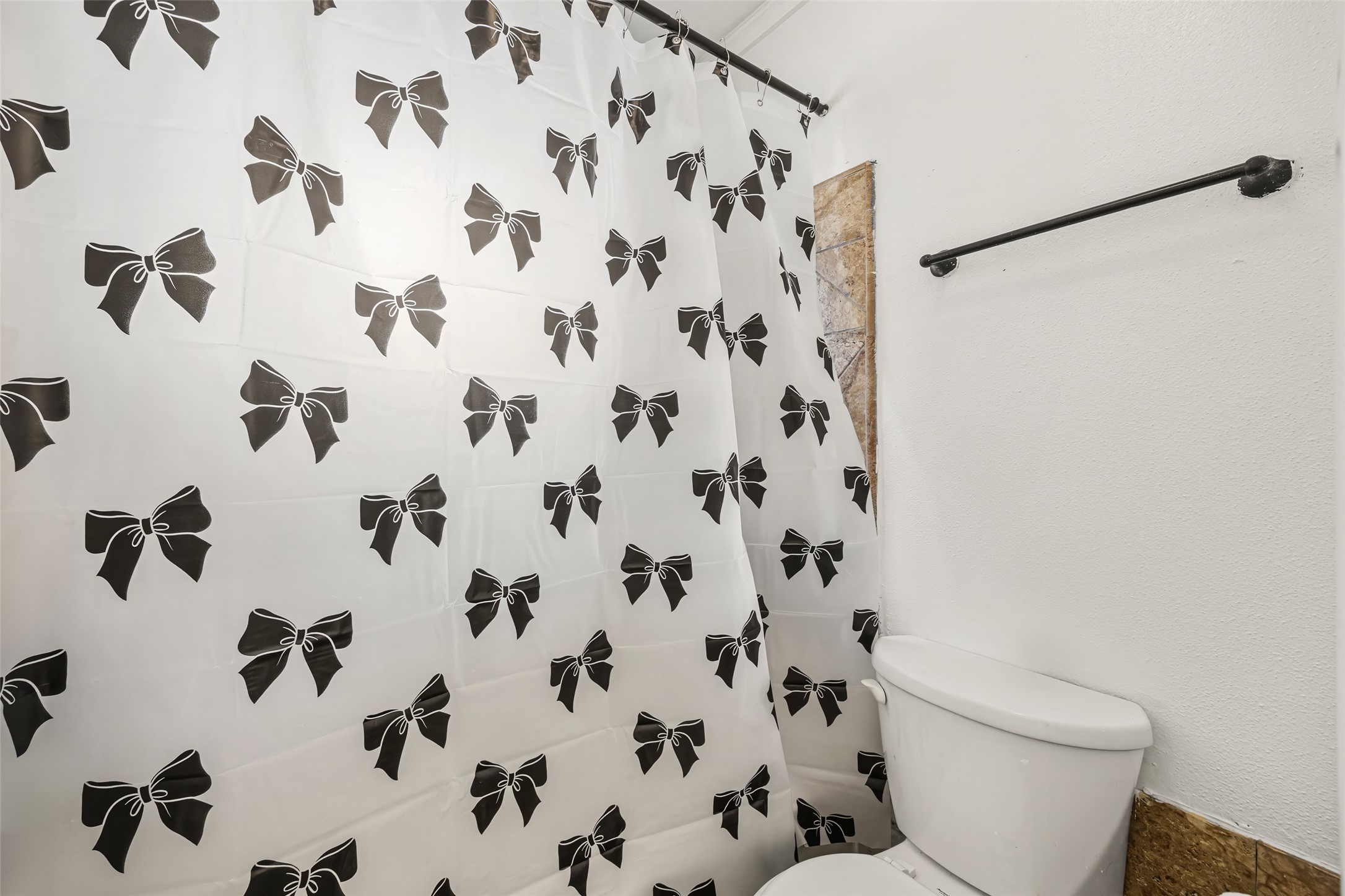 7226 Ridgeberry Drive Houston, TX 77095 - Photo 19 of 31 a white toilet sitting next to a white curtain