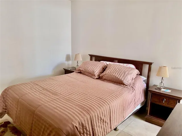 a bedroom with a bed and a lamp