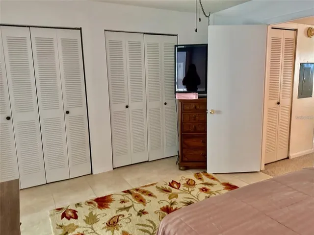 a bedroom with a bed and a walk in closet