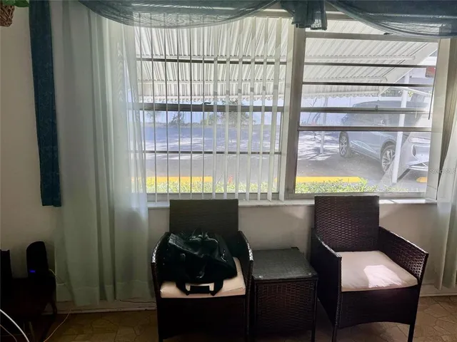 a dining room with furniture and window