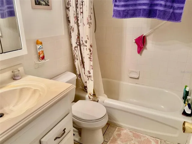 a bathroom with a white bath tub a sink and a toilet