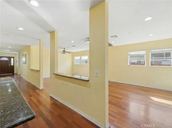 a view of a hallway with wooden floor