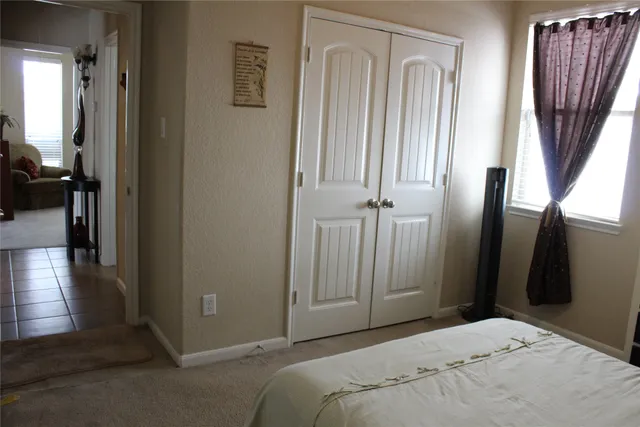 a bedroom with a bed and a mirror