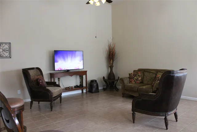 a living room with furniture and a piano