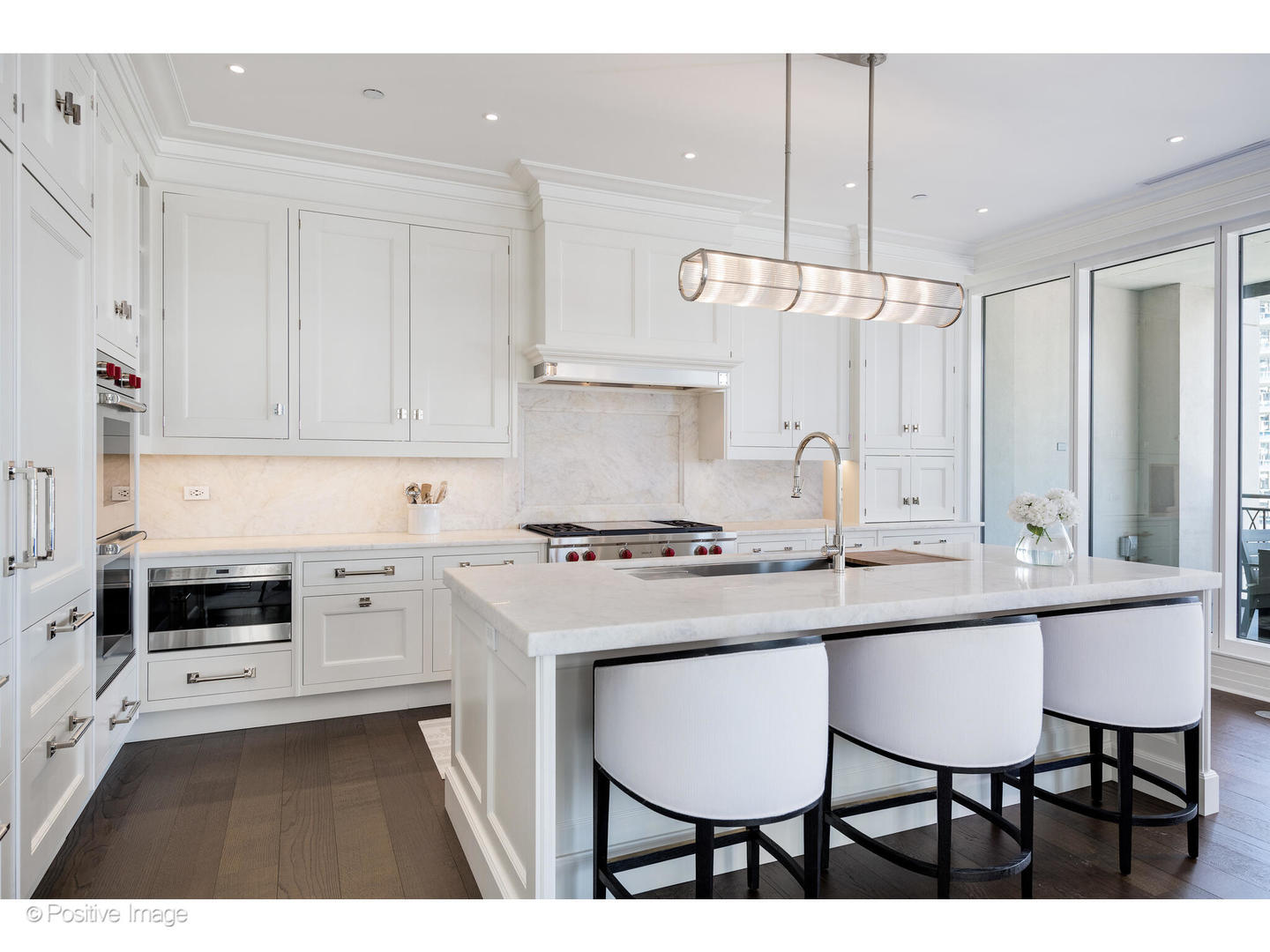 9 West Walton Street, Unit 1501 Chicago, IL 60610 - Photo 15 of 37 a kitchen with a sink stove and white cabinets