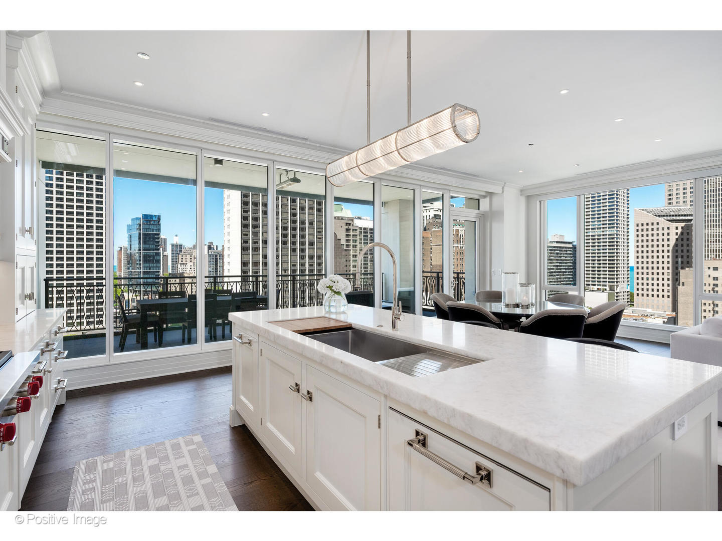 9 West Walton Street, Unit 1501 Chicago, IL 60610 - Photo 19 of 37 a large white kitchen with a large window