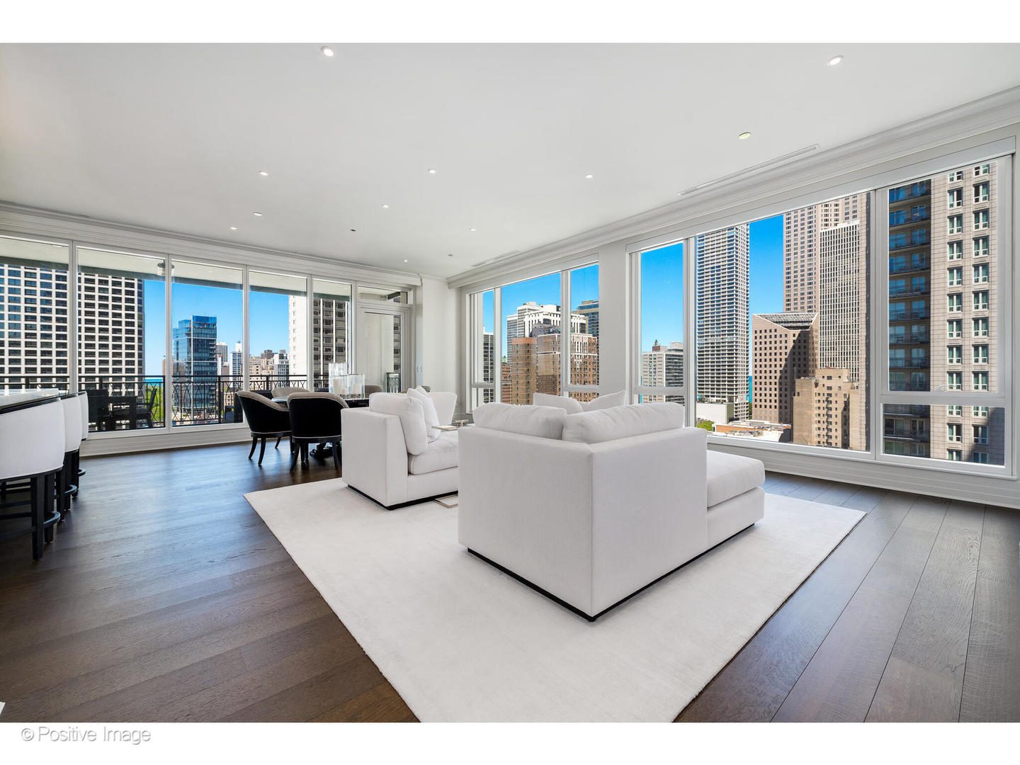 9 West Walton Street, Unit 1501 Chicago, IL 60610 - Photo 5 of 37 a living room with furniture a large window and wooden floor