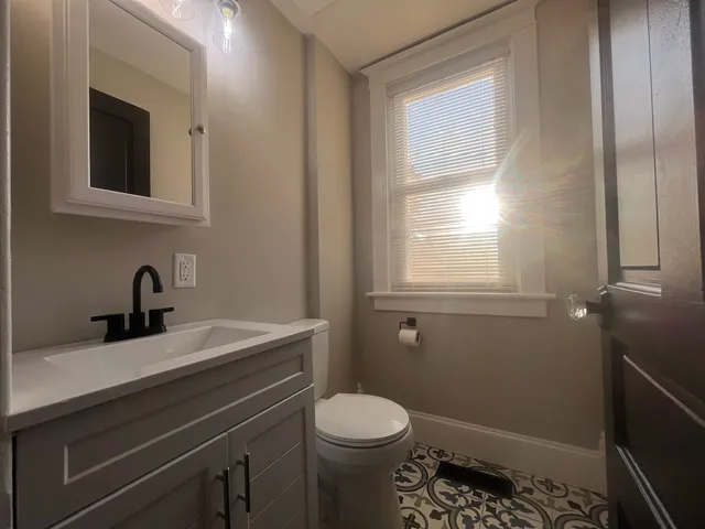 a bathroom with a sink toilet and vanity