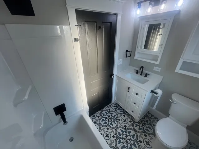 a bathroom with a sink toilet and shower