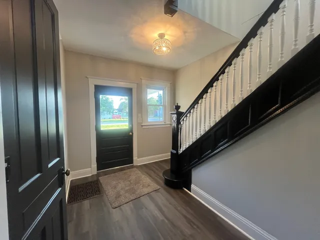 a view of an entryway with wooden floor