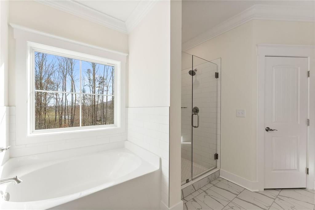 6998 Britt Gailey Road Clermont, GA 30527 - Photo 38 of 92 a bathroom with a bathtub and shower