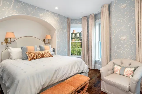 a bedroom with a bed couch and window