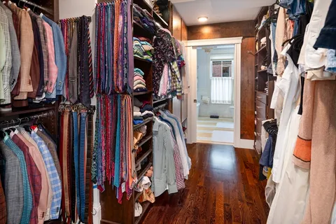 a view of walk in closet with clothes