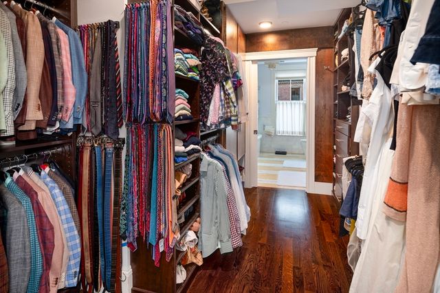 a view of walk in closet with clothes