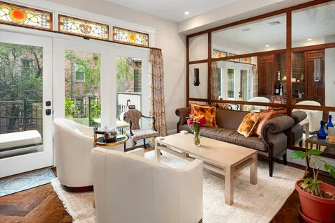 a living room filled with furniture and floor to ceiling windows
