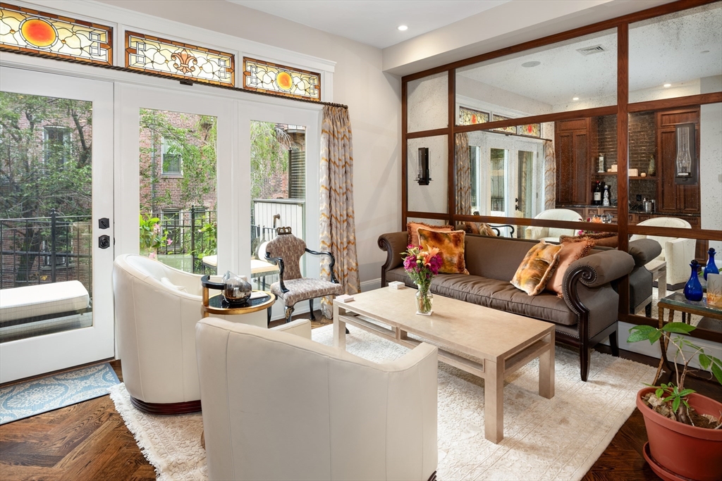109 Appleton Street Boston, MA 02116 - Photo 7 of 30 a living room filled with furniture and floor to ceiling windows