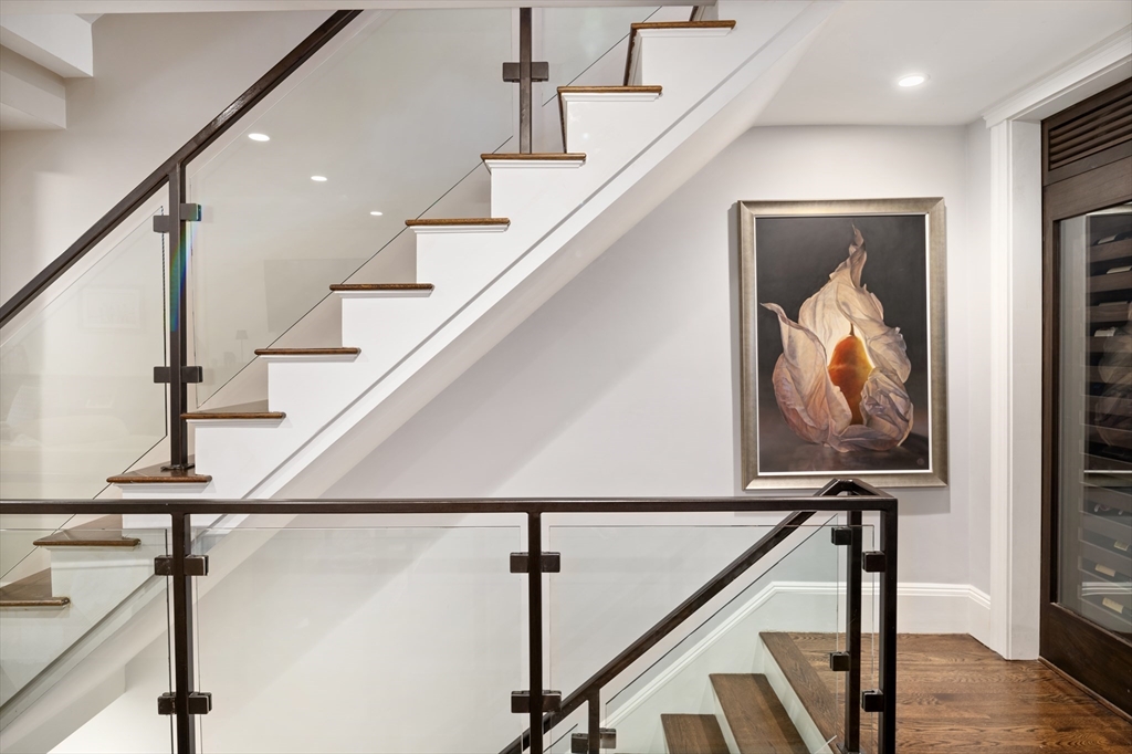 109 Appleton Street Boston, MA 02116 - Photo 8 of 30 a view of a hallway with wooden floor and stairs