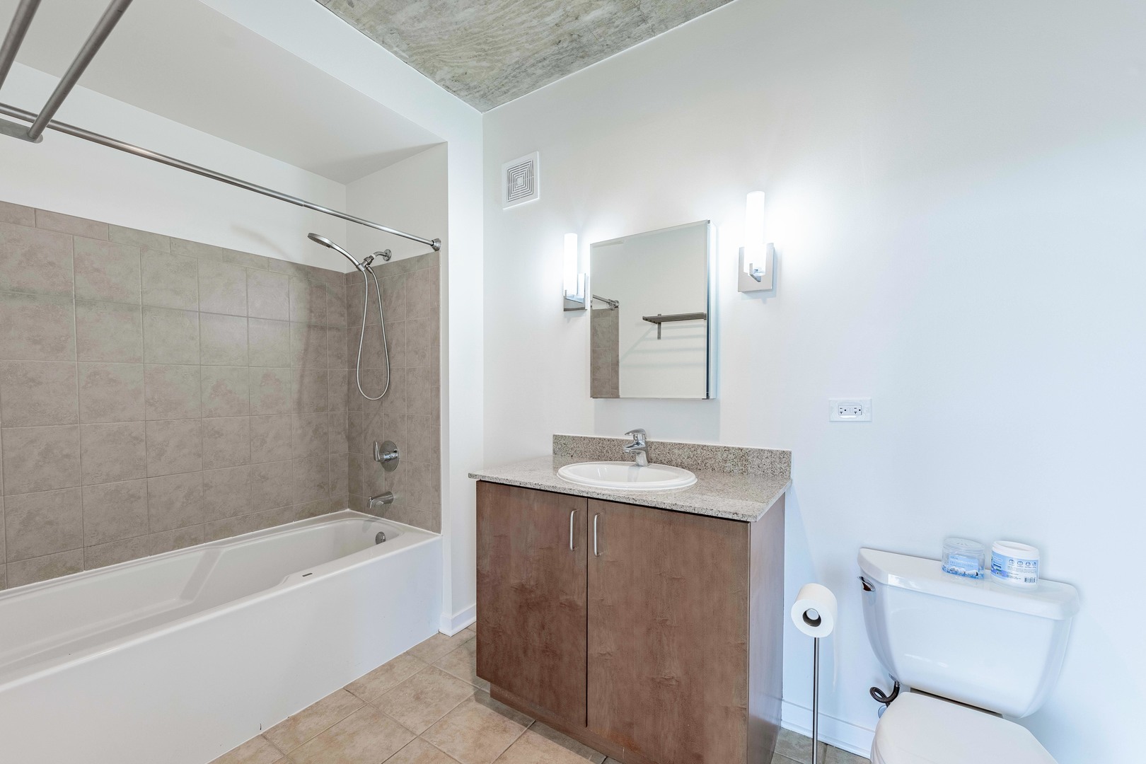 611 South Wells Street, Unit 2301 Chicago, IL 60607 - Photo 23 of 25 a bathroom with a granite countertop sink toilet and shower