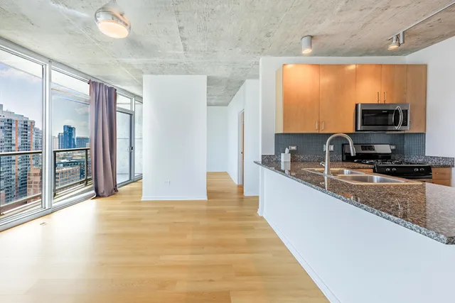 a view of a kitchen with a sink and a large window