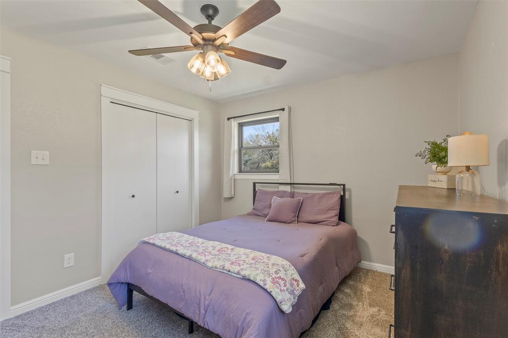 3009 Ranch House Road Willow Park, TX 76087 - Photo 24 of 40 a bedroom with a bed and a chandelier