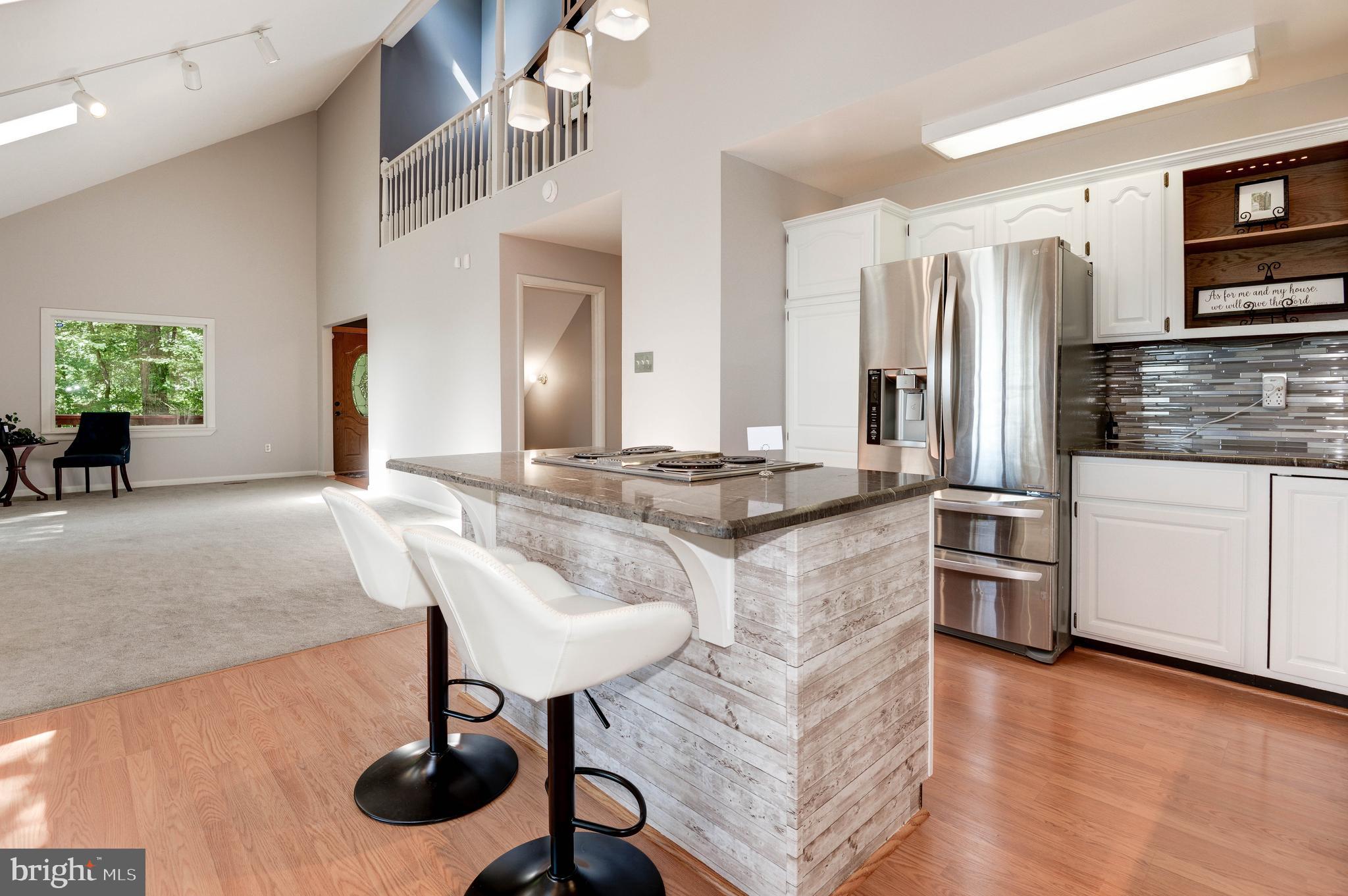 1619 Summit Drive Haymarket, VA 20169 - Photo 7 of 62 a kitchen with stainless steel appliances granite countertop a sink and a refrigerator