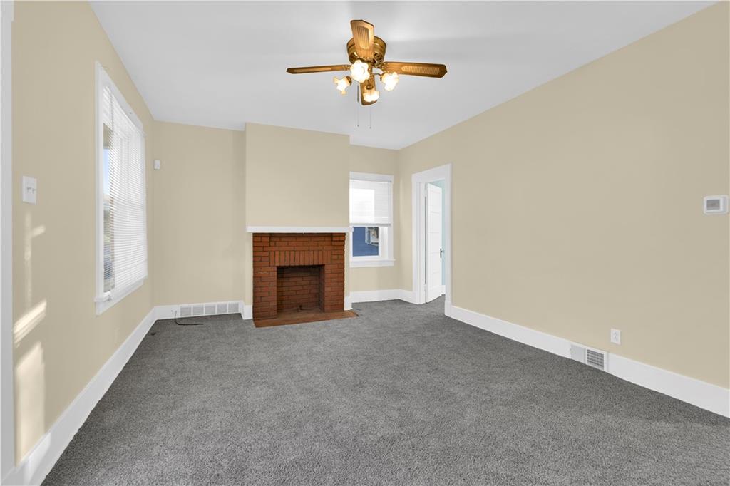2071-2073 Brodhead Road Aliquippa, PA 15001 - Photo 12 of 34 a view of a livingroom with a fireplace and a chandelier fan