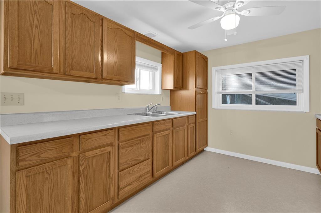 2071-2073 Brodhead Road Aliquippa, PA 15001 - Photo 22 of 34 a kitchen with granite countertop white cabinets and stainless steel appliances