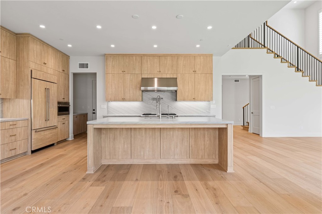 233 Pinnacle Irvine, CA 92602 - Photo 26 of 64 a kitchen with stainless steel appliances a refrigerator and wooden floor