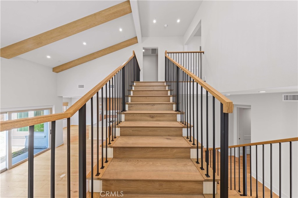233 Pinnacle Irvine, CA 92602 - Photo 32 of 64 a view of staircase with lots of frames on wall and wooden floor