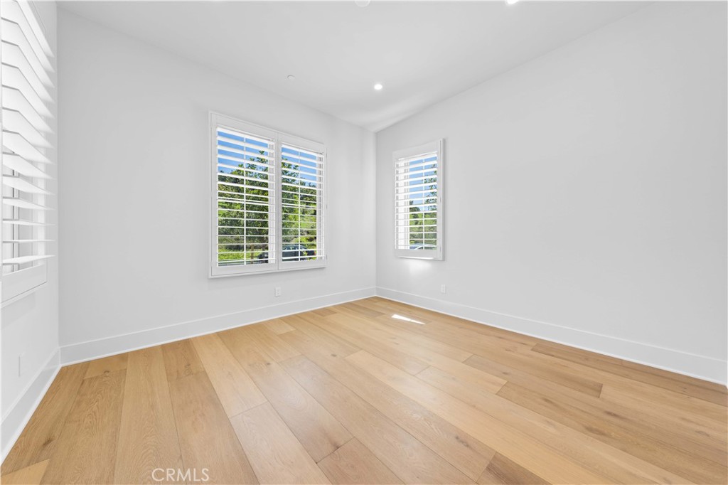 233 Pinnacle Irvine, CA 92602 - Photo 7 of 64 a view of an empty room with wooden floor and a window