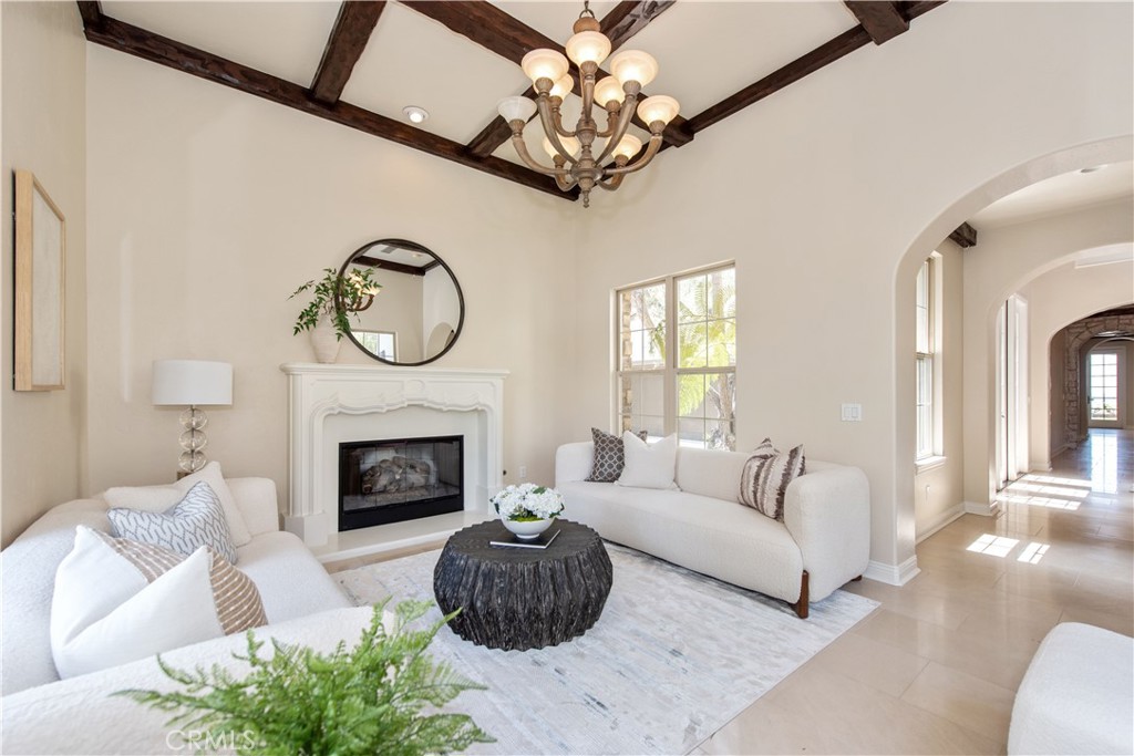 17 Ferrand Newport Coast, CA 92657 - Photo 2 of 34 a living room with furniture a fireplace and a chandelier