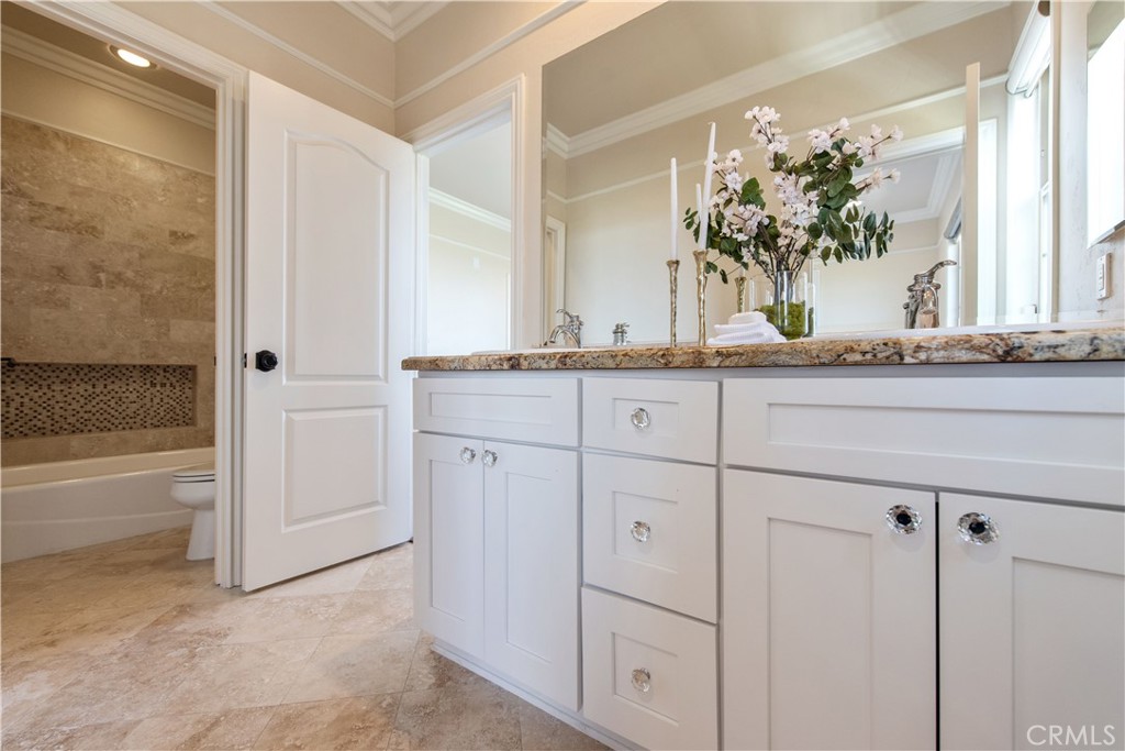 17 Ferrand Newport Coast, CA 92657 - Photo 29 of 34 a bathroom with a granite countertop sink and a mirror