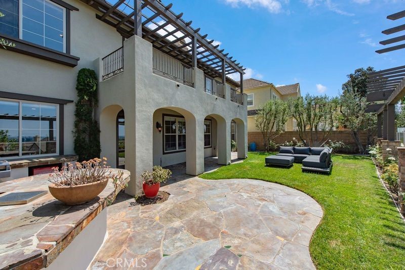 17 Ferrand Newport Coast, CA 92657 - Photo 31 of 34 a view of a patio with dining table and chairs with a fire pit