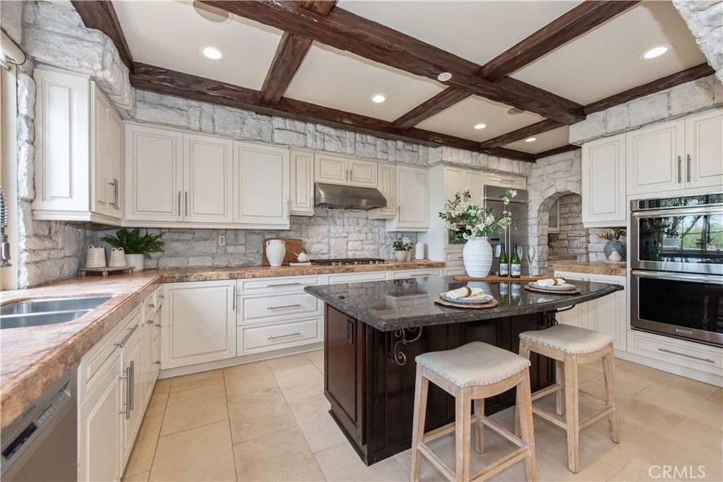 17 Ferrand Newport Coast, CA 92657 - Photo 8 of 34 a kitchen with a sink stove and cabinets