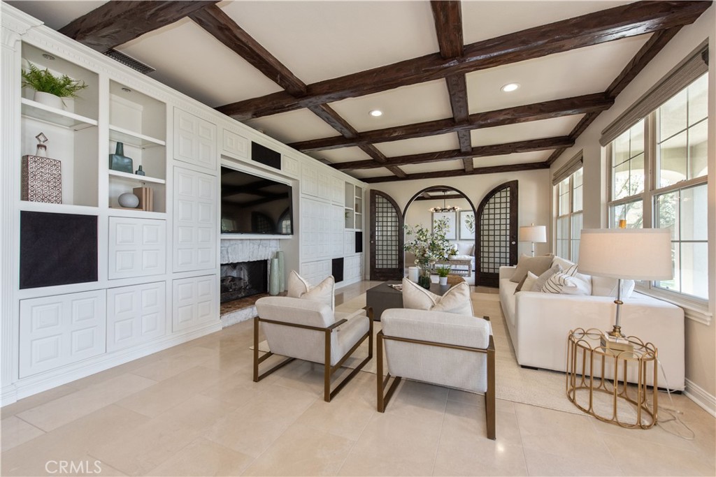 17 Ferrand Newport Coast, CA 92657 - Photo 10 of 34 a living room with furniture a fireplace and a flat screen tv