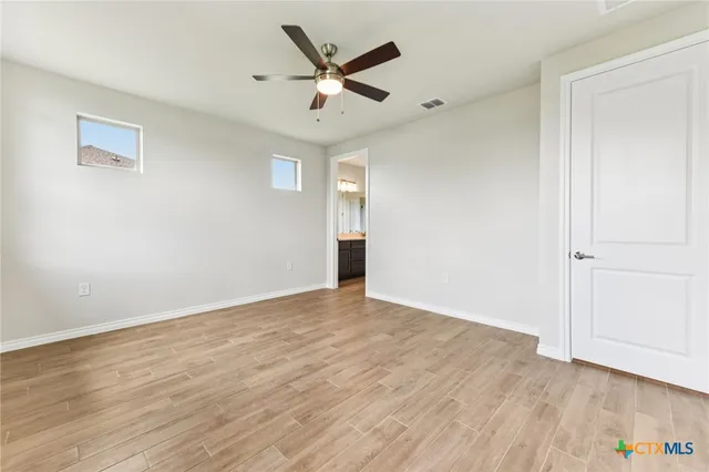 a spacious bathroom with a shower a sink and a mirror