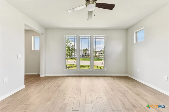 wooden floor in an empty room with a window