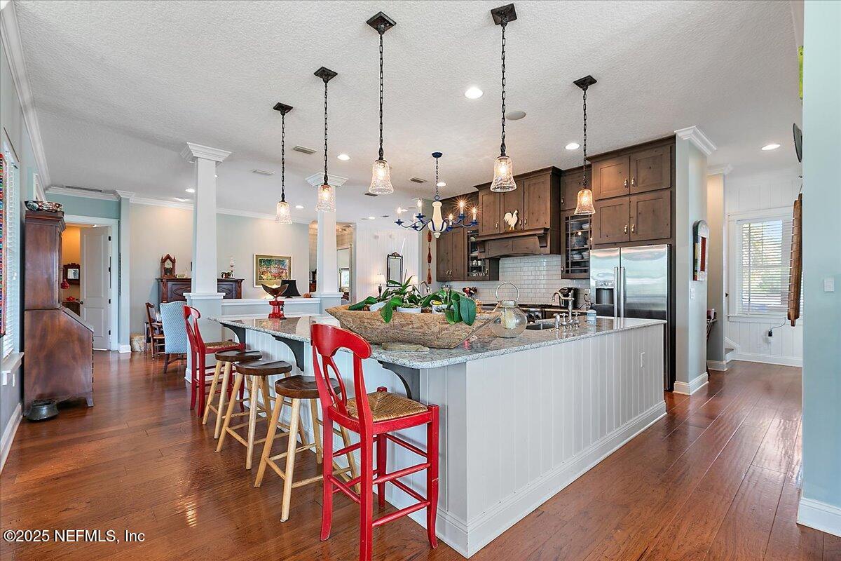 411 Ranch Road Ponte Vedra, FL 32081 - Photo 17 of 56 a kitchen with stainless steel appliances granite countertop a stove a refrigerator a oven a sink with a dining table and chairs