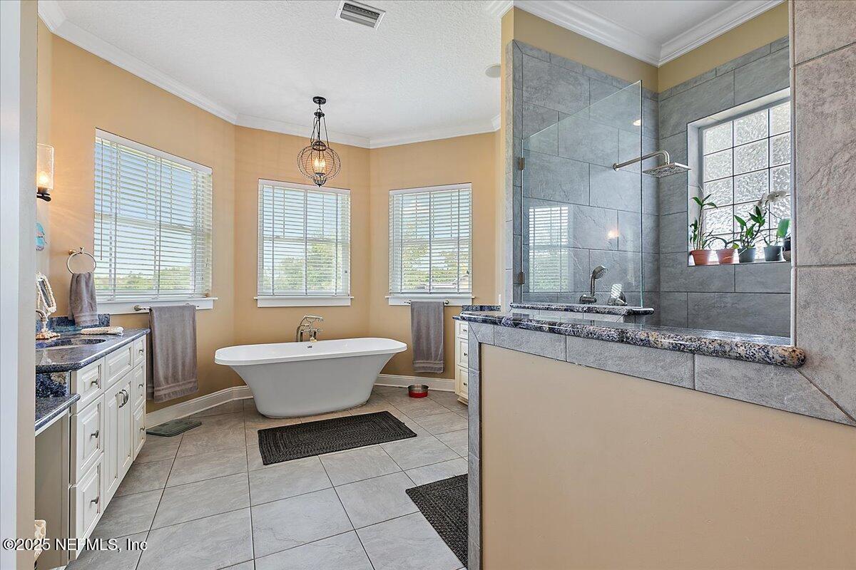 411 Ranch Road Ponte Vedra, FL 32081 - Photo 22 of 56 a bathroom with a tub sink and mirror