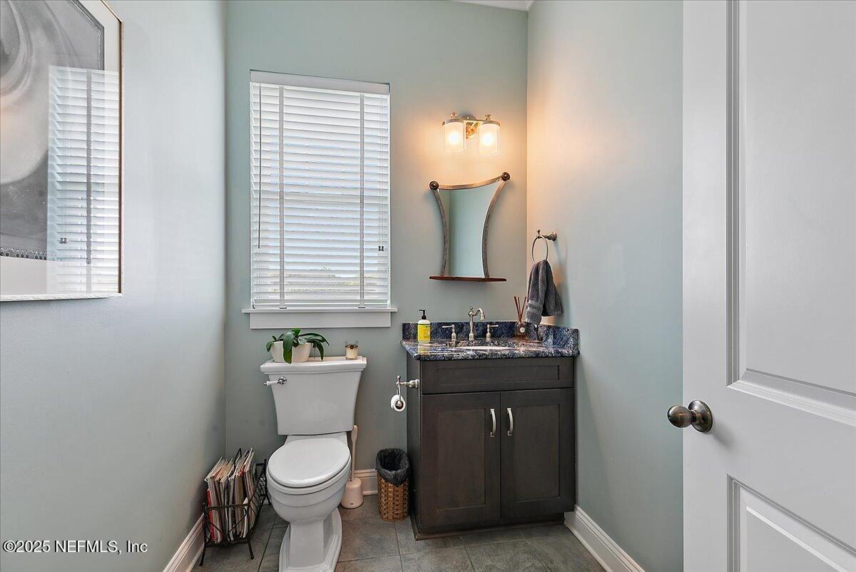 411 Ranch Road Ponte Vedra, FL 32081 - Photo 25 of 56 a bathroom with a toilet a sink and mirror