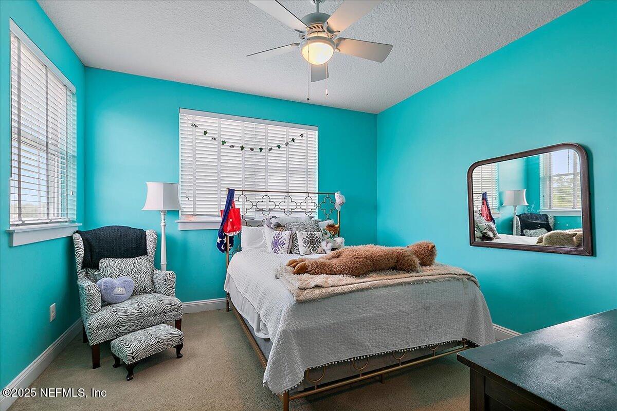 411 Ranch Road Ponte Vedra, FL 32081 - Photo 31 of 56 a bedroom with a bed and a chandelier