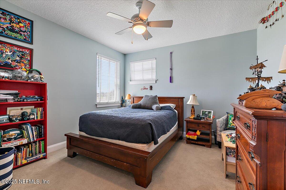 411 Ranch Road Ponte Vedra, FL 32081 - Photo 34 of 56 a bedroom with a bed and a book shelf