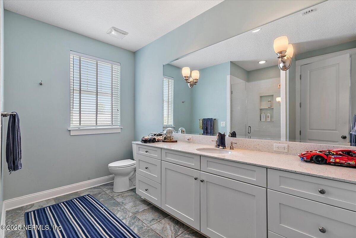 411 Ranch Road Ponte Vedra, FL 32081 - Photo 35 of 56 a bathroom with a double vanity sink a toilet and a window