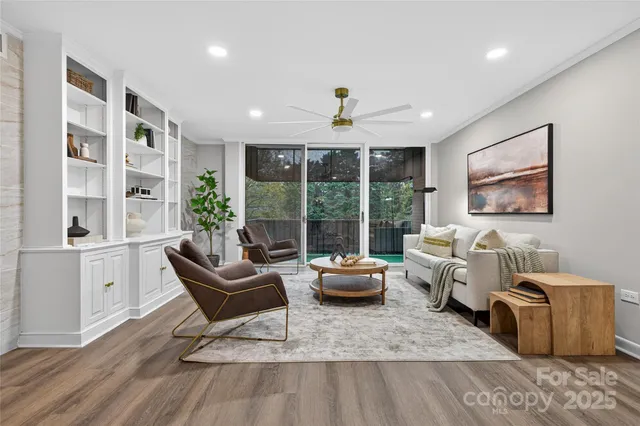 a living room with furniture and large windows