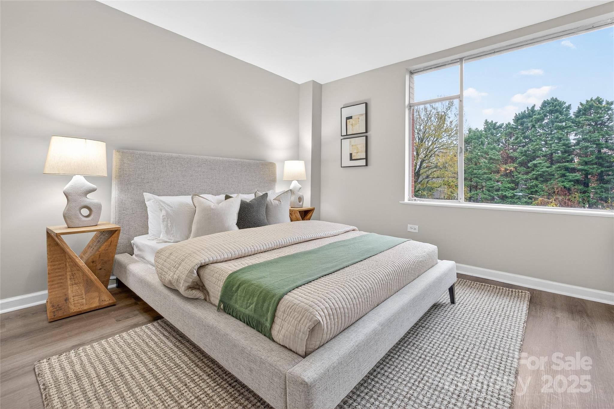 1300 Queens Road, Unit 409 Charlotte, NC 28207 - Photo 14 of 35 a bedroom with a bed lamp and window